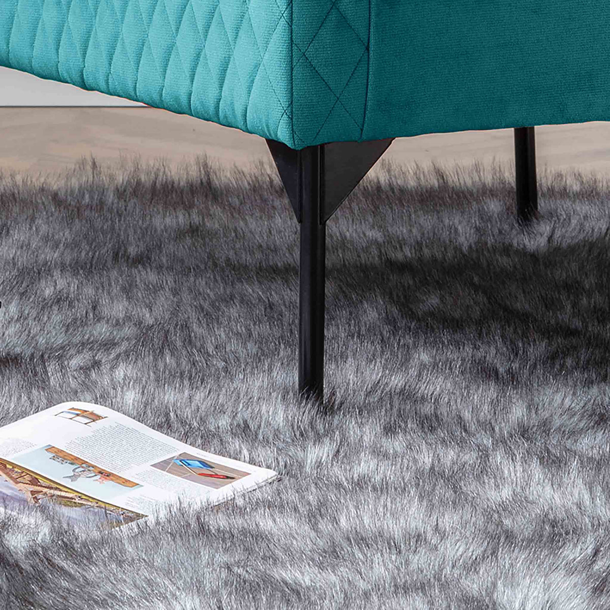 lifestyle close up of the black legs on the Bali Lagoon Velvet Accent Chair