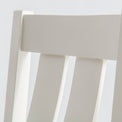 close up of the wooden back rest on The Padstow White Wooden Dining Chair with Padded Seat