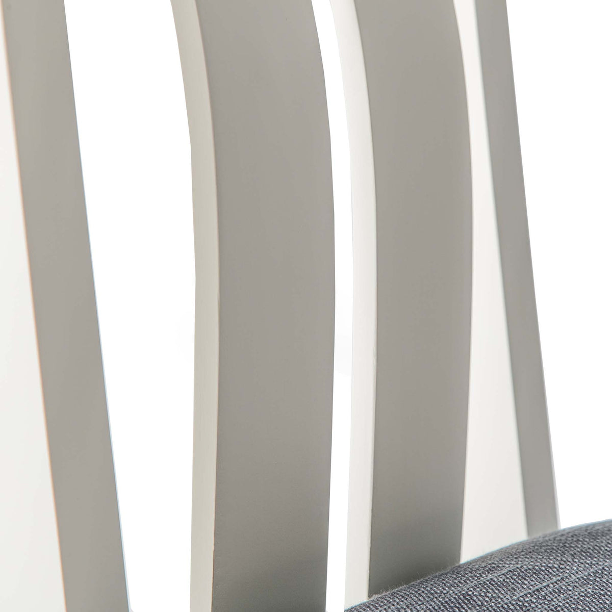 close up of the curved slats on The Padstow White Wooden Dining Chair with Padded Seat