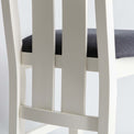 rear view close up of the slatted backrest on The Padstow White Wooden Dining Chair with Padded Seat