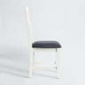 Side view of the The Padstow White Wooden Dining Chair with Padded Seat