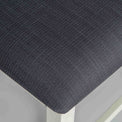 close up of the black fabric seat on The Padstow White Wooden Dining Chair