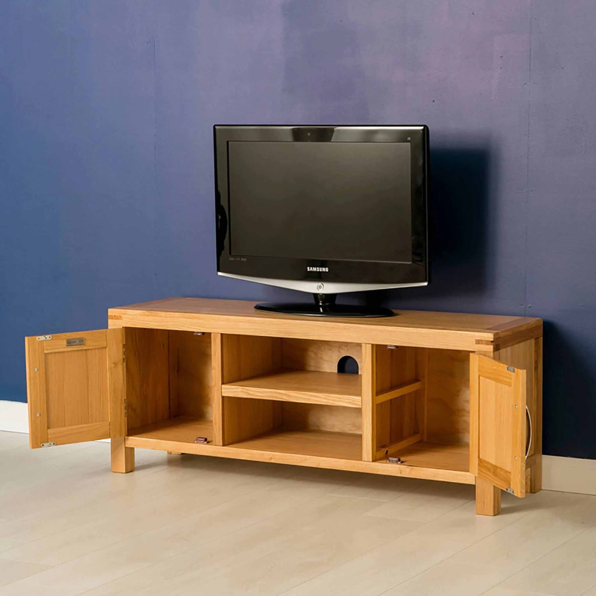 Inside view of the Abbey Light Oak Large Television Stand  - Lifestyle with doors open