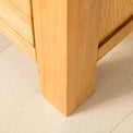 Back leg view of the Abbey Light Oak Chest of Drawers by Roseland Furniture