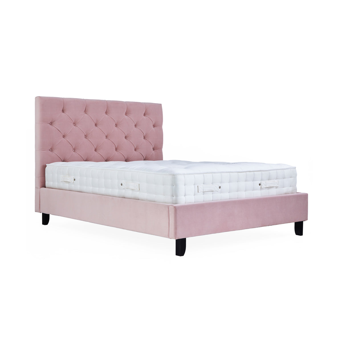 A pink upholstered bed with a tufted headboard and a white mattress stands against a white background.