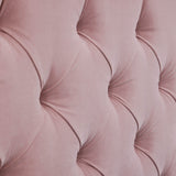 A close-up of a pink, tufted fabric forming a diamond pattern with visible stitching and shadows accentuating its plush texture.