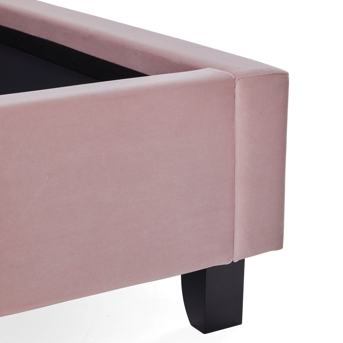 A pink upholstered ottoman with an open black interior and a single black leg visible, isolated on a white background.