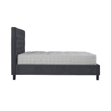 A dark gray upholstered bed frame with a tall, tufted headboard holds a thick white mattress in an evenly lit, blank setting.