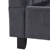 A close-up of a dark grey sofa corner with a visible black leg against a white background.