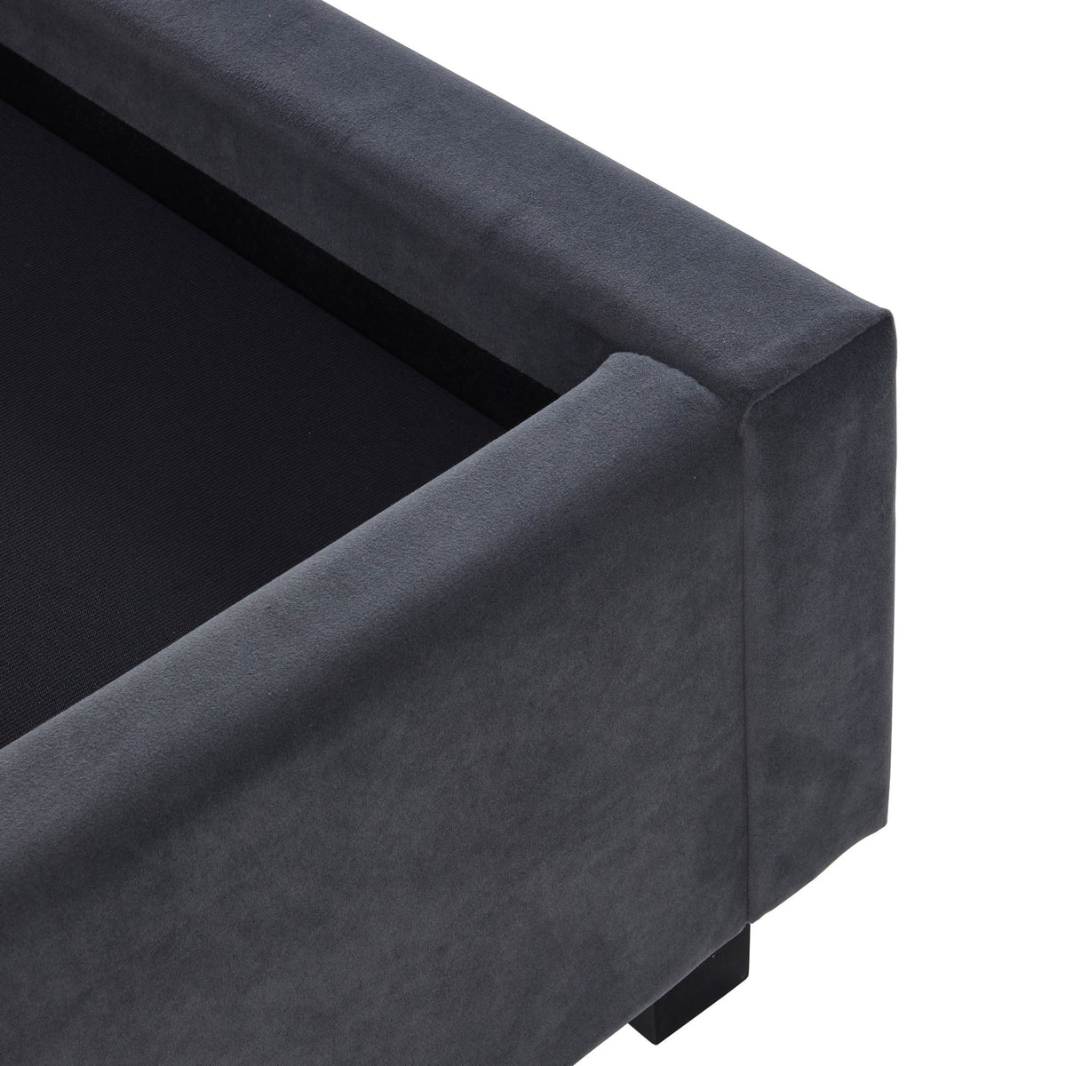 A dark gray upholstered sofa corner against a plain background, with focus on its clean lines and fabric texture; no evident action or additional context.