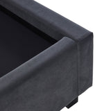 A dark gray upholstered sofa corner against a plain background, with focus on its clean lines and fabric texture; no evident action or additional context.