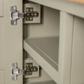 Close up of the cabinet door hinges on the Chichester Ledum Green Small TV Unit