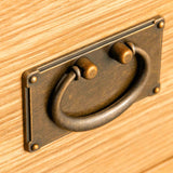 Surrey Oak 5 Wide Drawer Chest - close up of brass dropdown handle