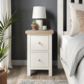 Farrow Coconut White Slim Bedside Table with Washed Oak Top and wooden handles from Roseland Furniture