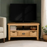 Surrey Oak Corner TV Stand with Basket in corner of a living room from Roseland Furniture