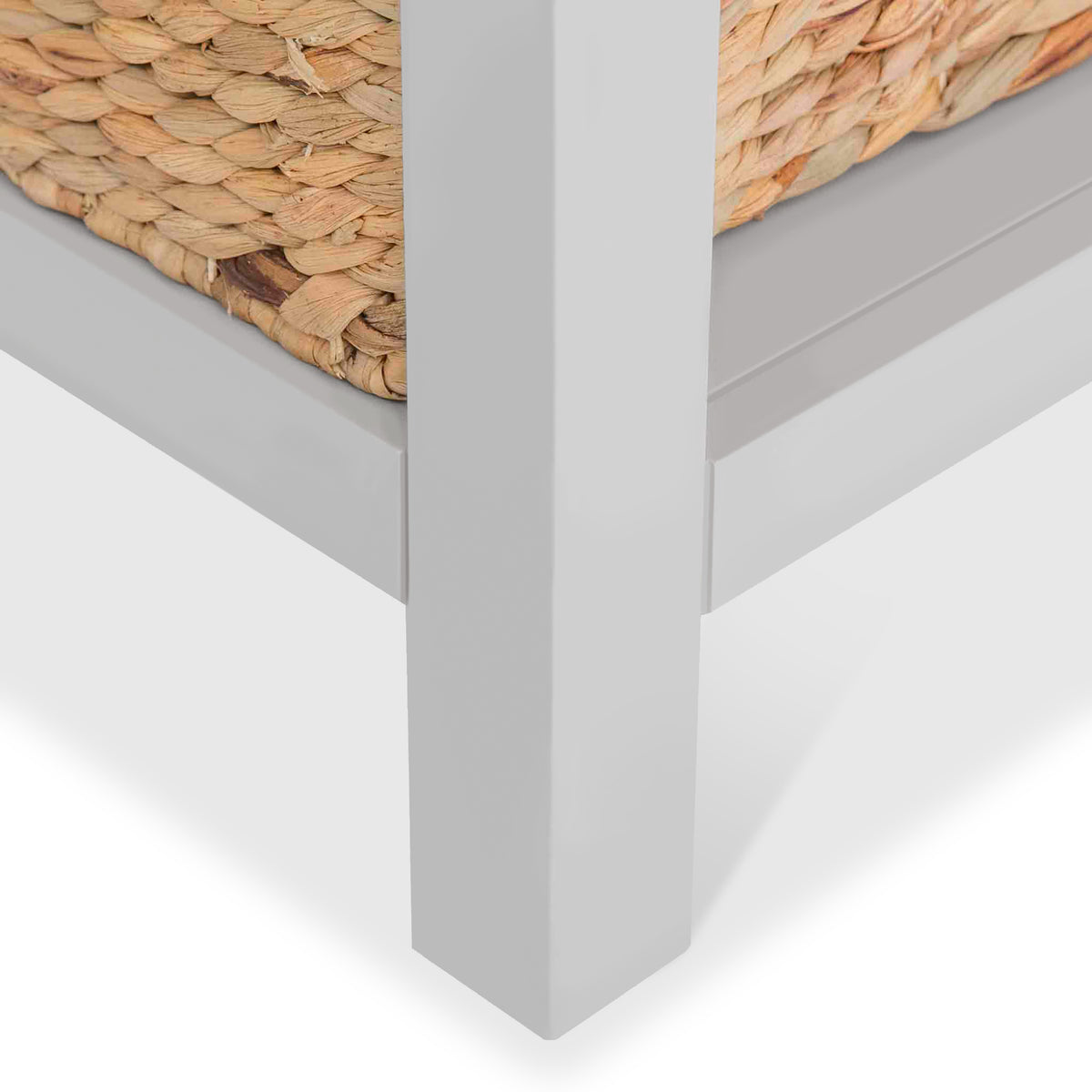 a close up shot of the leg of a wooden storage cabinet with wicker baskets