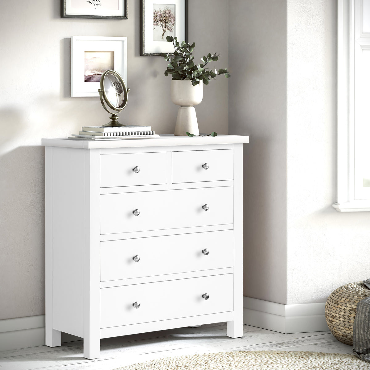 A white wooden dresser with seven drawers, each featuring a simple round knob, stands isolated against a plain background.