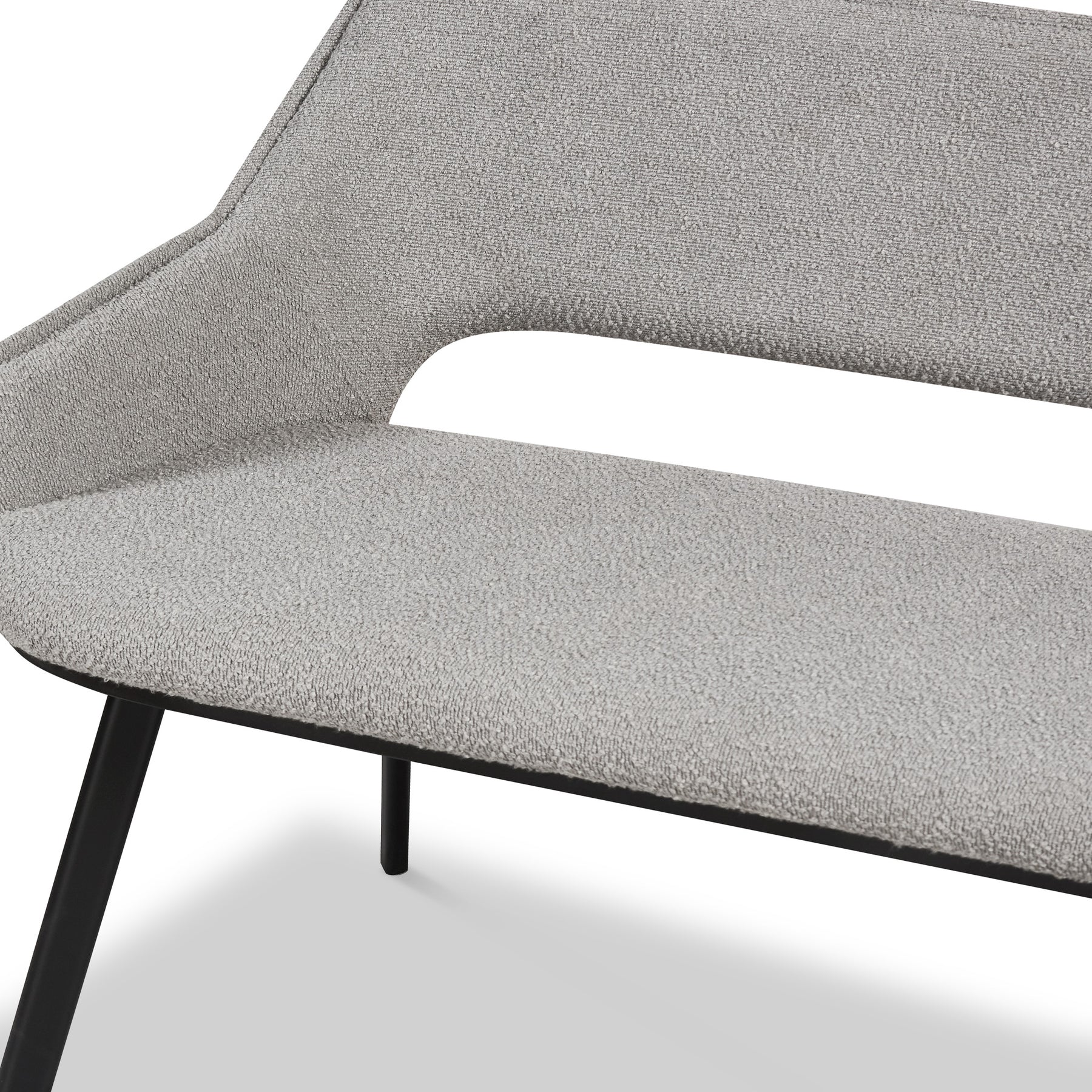 A grey fabric chair with a cutout backrest detail and black metal legs, displayed on a plain white background.