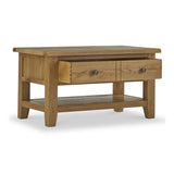 A wooden coffee table with two drawers and a lower shelf, isolated on a white background.