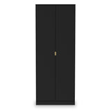 A tall black wardrobe stands with closed doors and a single gold-colored handle, isolated against a white background.