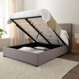 Brent Ottoman Storage Bed Frame from Roseland Furniture- Gray upholstered bed with raised headboard in a bedroom setting