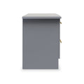 A grey, freestanding pedestal with a flat top, gold handles, and a drawer slightly ajar, isolated against a white background.
