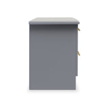 A grey, freestanding pedestal with a flat top, gold handles, and a drawer slightly ajar, isolated against a white background.