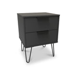 A modern black bedside table with two closed drawers, supported by thin metal legs, stands isolated on a white background.