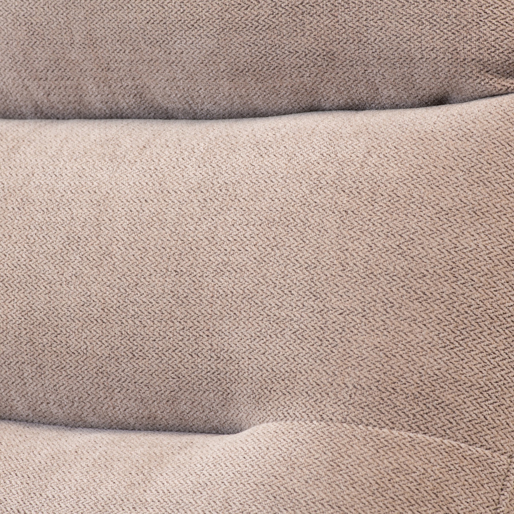 Folded beige fabric with a textured pattern, resting, likely a textile or garment in close-up view.