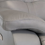 A close-up of a gray leather armchair with prominent stitching, highlighting texture and comfort.