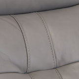 Close-up of a gray leather surface with stitching, possibly part of furniture like a sofa or chair, with no discernible action or context.