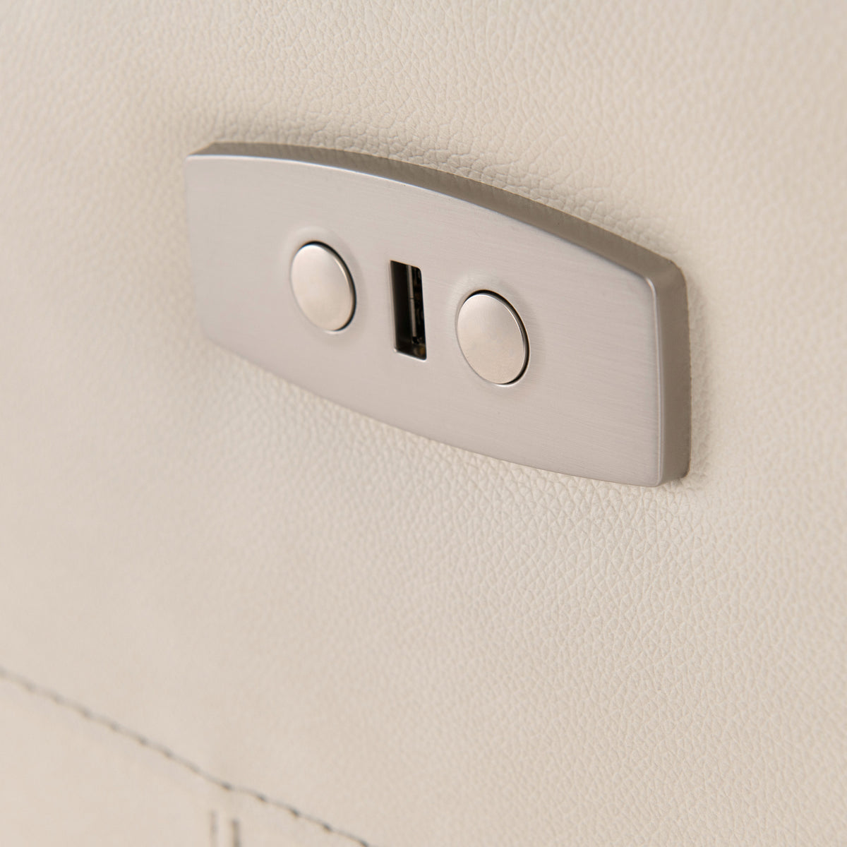 A dual USB port is mounted on a textured beige wall, providing a charging point in a modern interior setting.