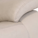 Close-up of a beige leather sofa showing stitching detail, texture, and cushioning, reflective of comfort and modern interior design.