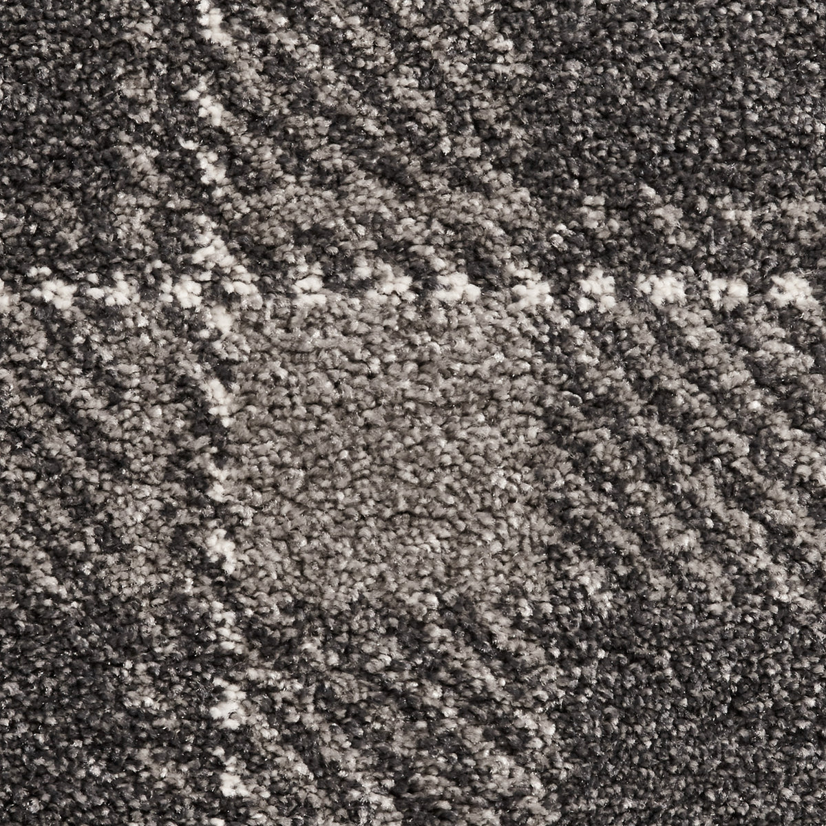 A close-up texture of a carpet with a mottled pattern of black, gray, and white fibers, creating no specific image or design.