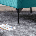 lifestyle close up of the black legs on the Bali Lagoon Velvet Accent Chair
