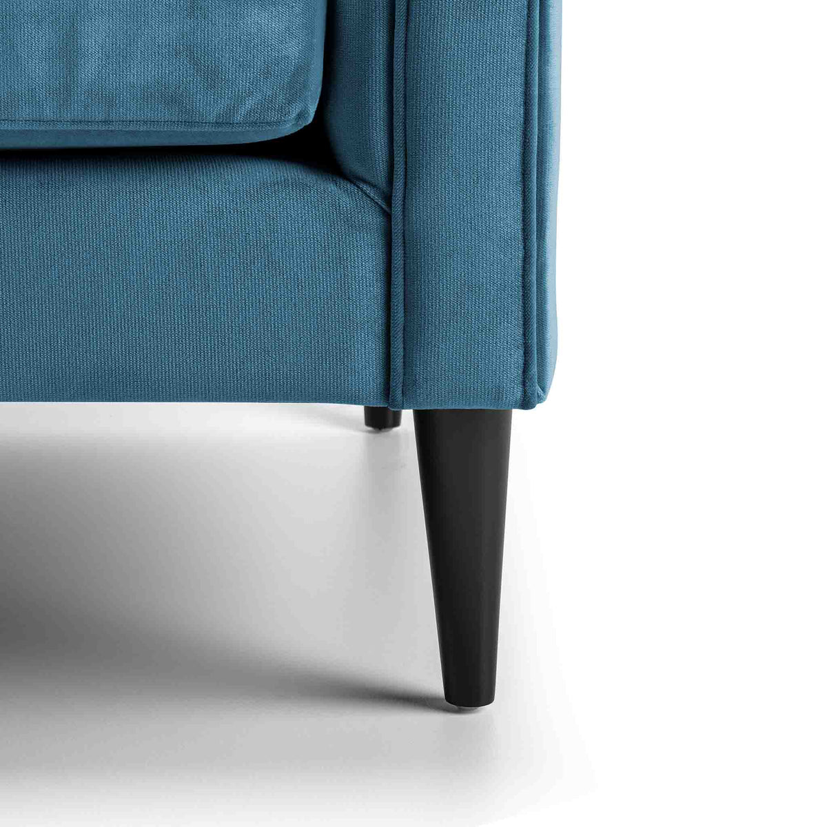 close up of the mid century solid wood tapered legs on the Savoy Peacock Velvet 2 Seater Accent Chair 