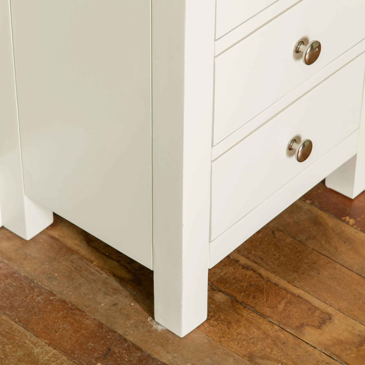 Close up of leg of The Cornish White Wooden 3 Drawer Bedside Table