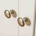 Close up of metal door knobs on The Cornish White Wooden Double Wardrobe