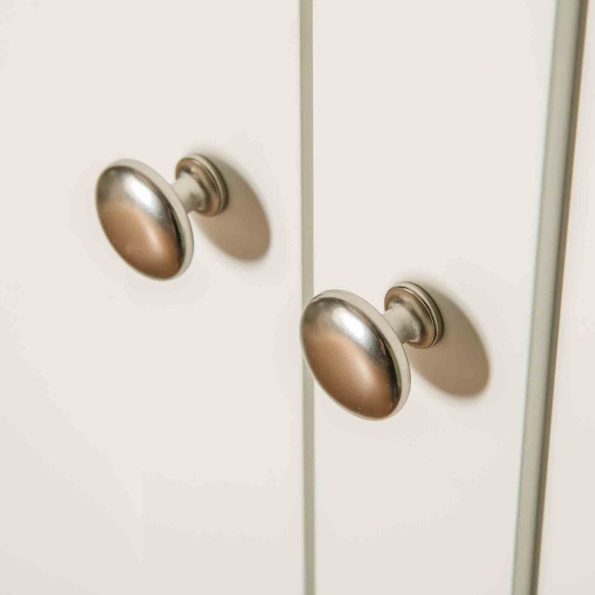 Close up of metal knobs on The Cornish White Large 3 Door Wardrobe