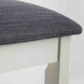 close up of padded seat and wooden frame on The Padstow White Wooden Dressing Stool 
