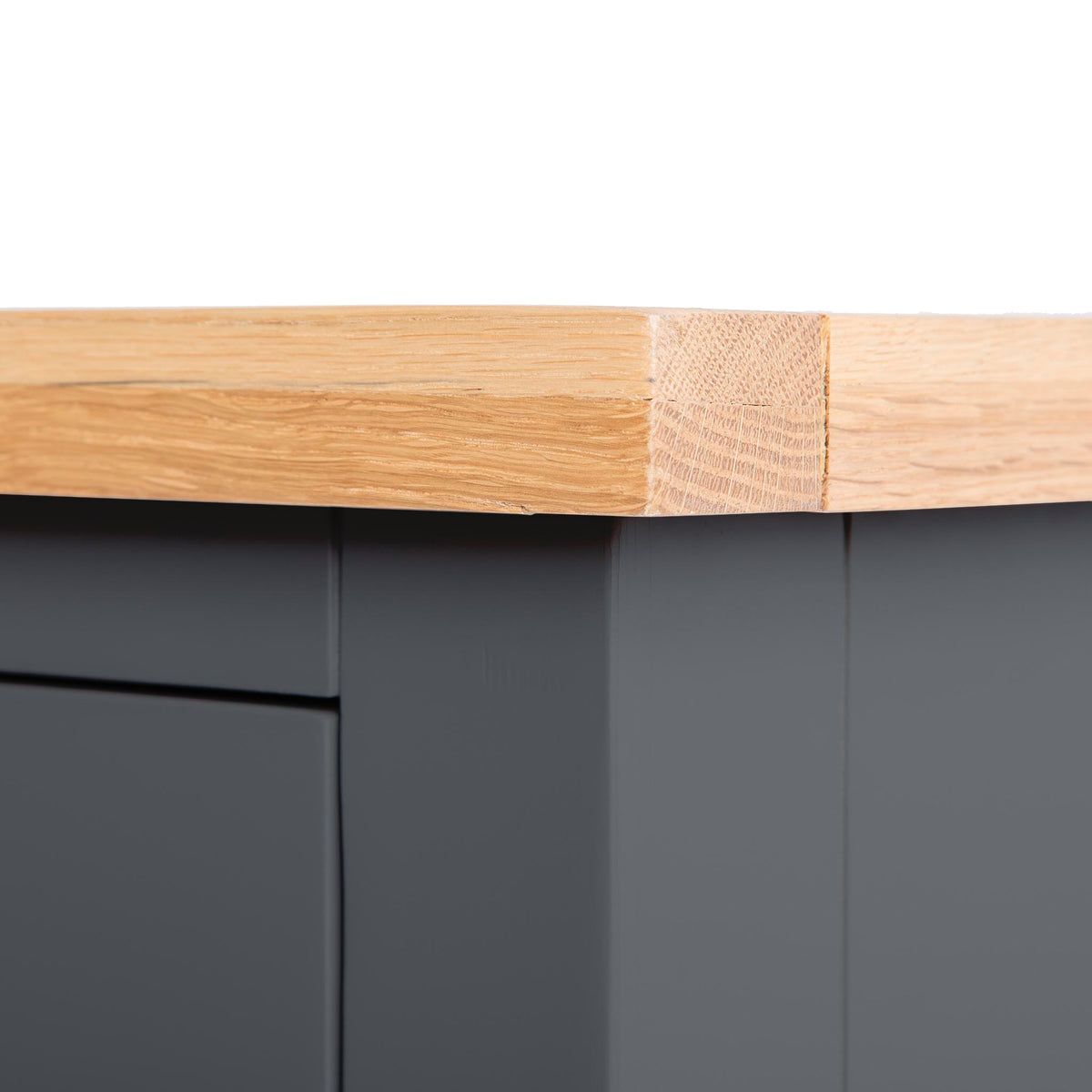 A wooden edge meets a dark vertical surface, converging at a right angle with a bandage applied over the intersection point.