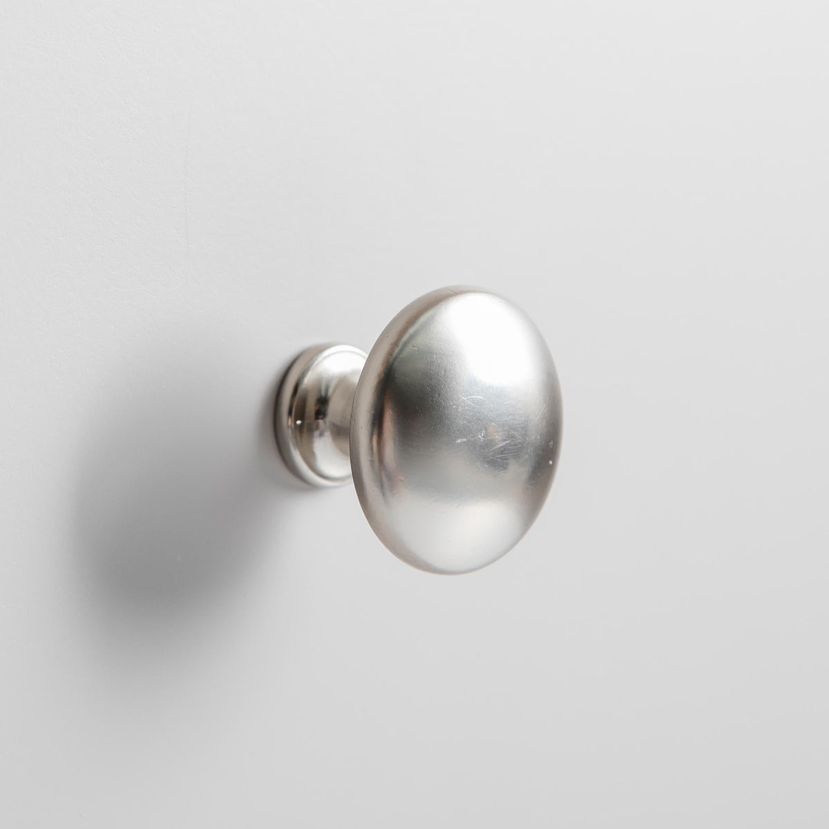 Close up of the round metal door knobs on the Farrow Grey Mini Sideboard