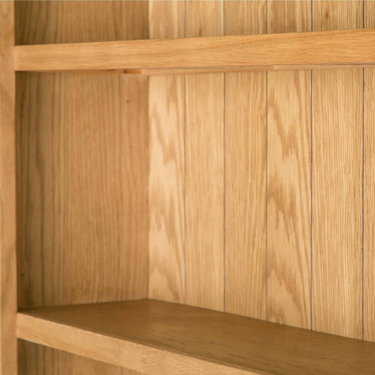 close up of the shelves on the Surrey Oak Large Bookcase by Roseland Furniture