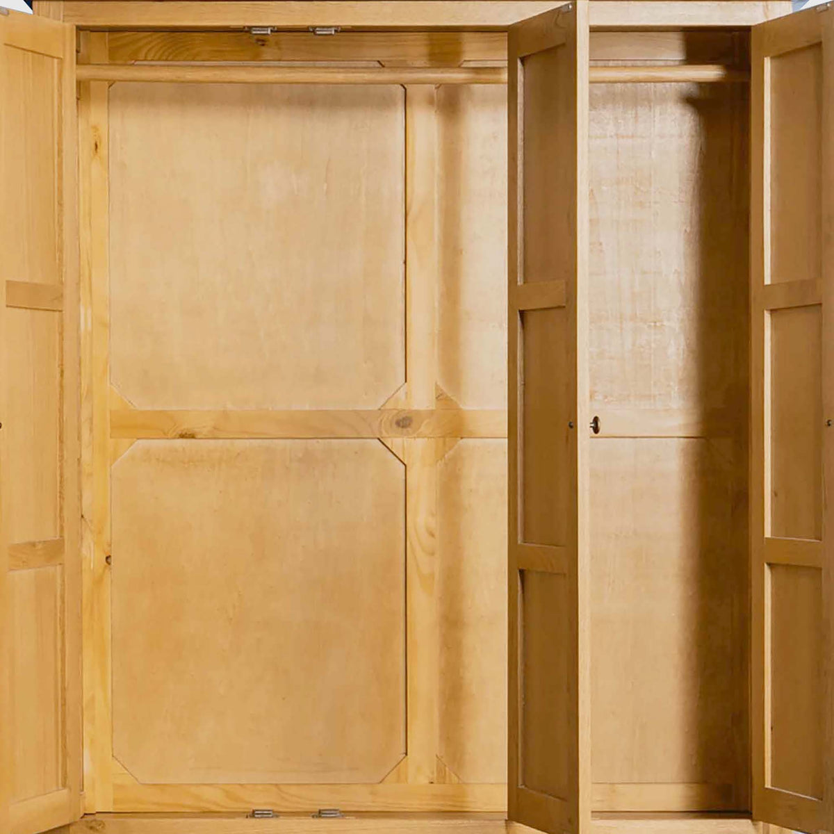 An empty wooden wardrobe with open doors, revealing interior shelves and compartments, against a plain background.