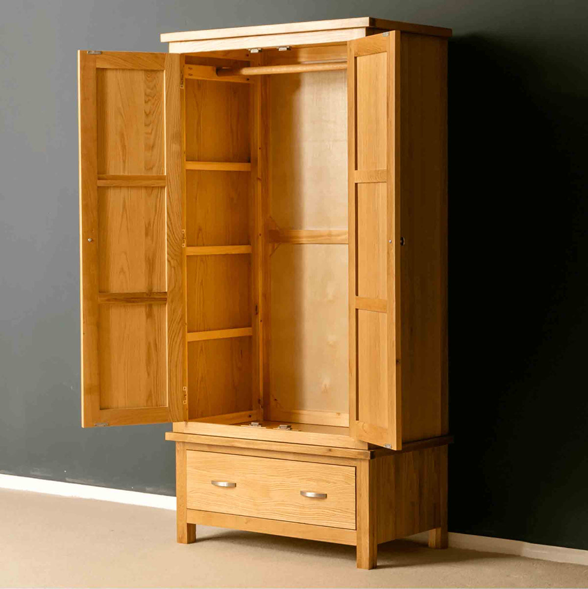 Modern oak double wardrobe with doors open.