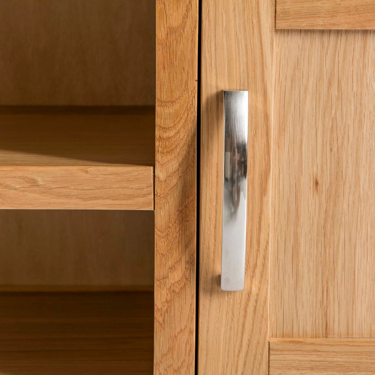 The Abbey Light Oak Large TV Stand - Close up of cupboard door handle and mid section shelves