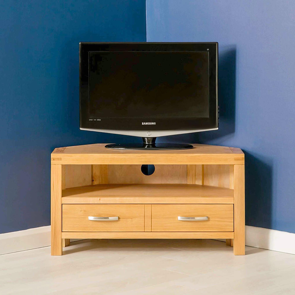 Abbey Light Oak Corner TV Stand - Lifestyle front view