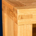 Corner joint of the Abbey Light Oak Corner TV Stand by Roseland Furniture