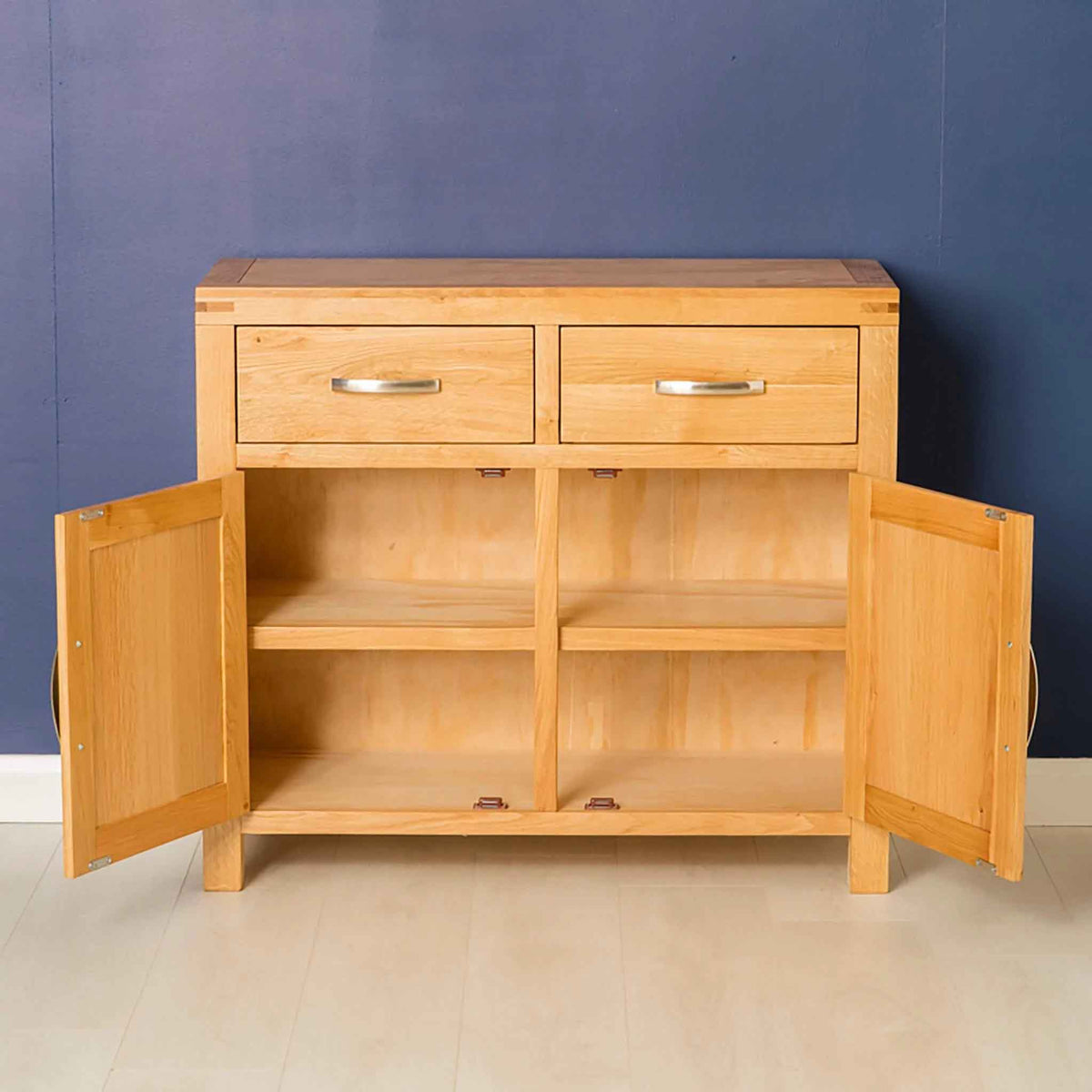 Inside view of the Abbey Light Oak Small Wooden Sideboard Cupboard - Lifestyle with doors open