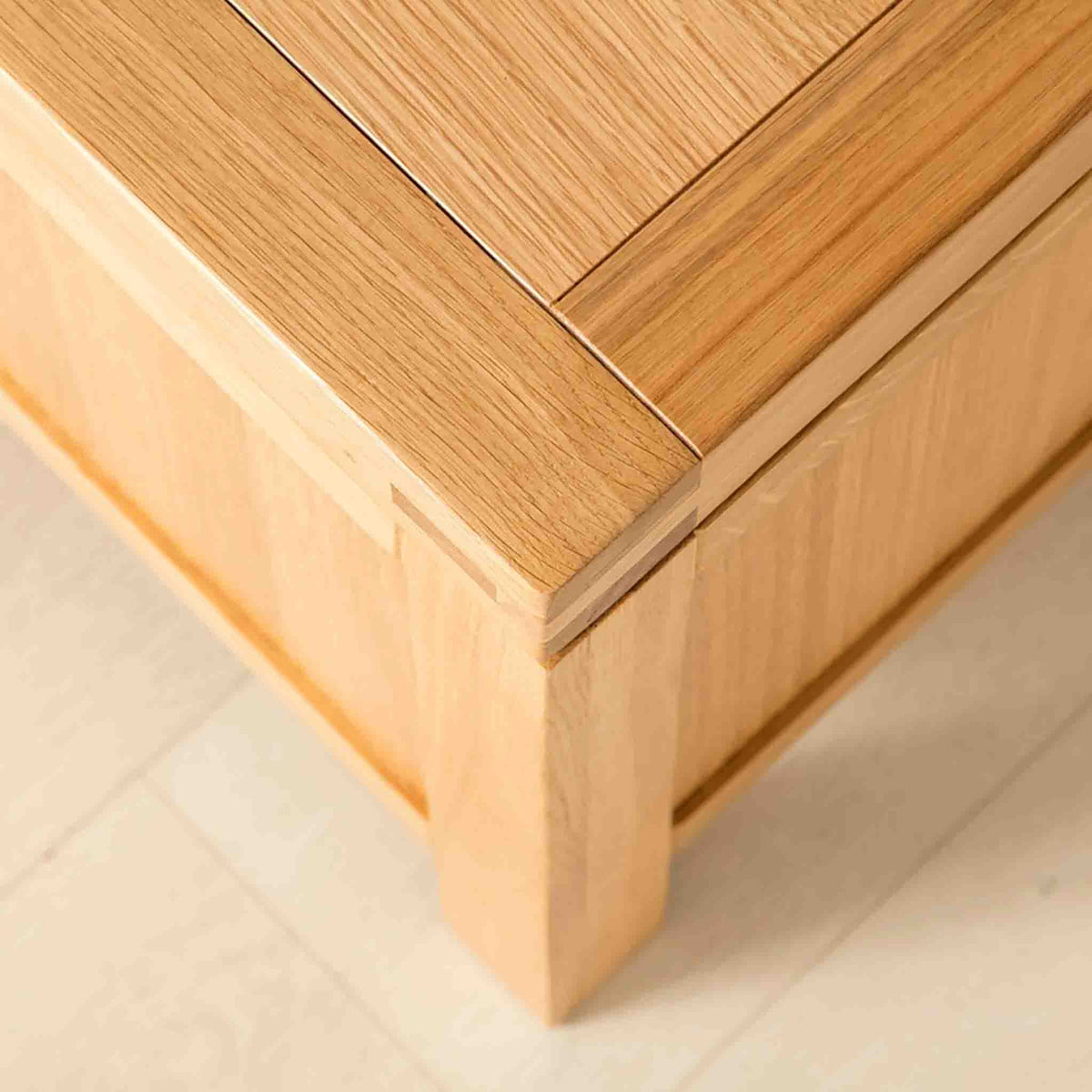 Topside corner view of the Abbey Light Oak Blanket Box by Roseland Furniture